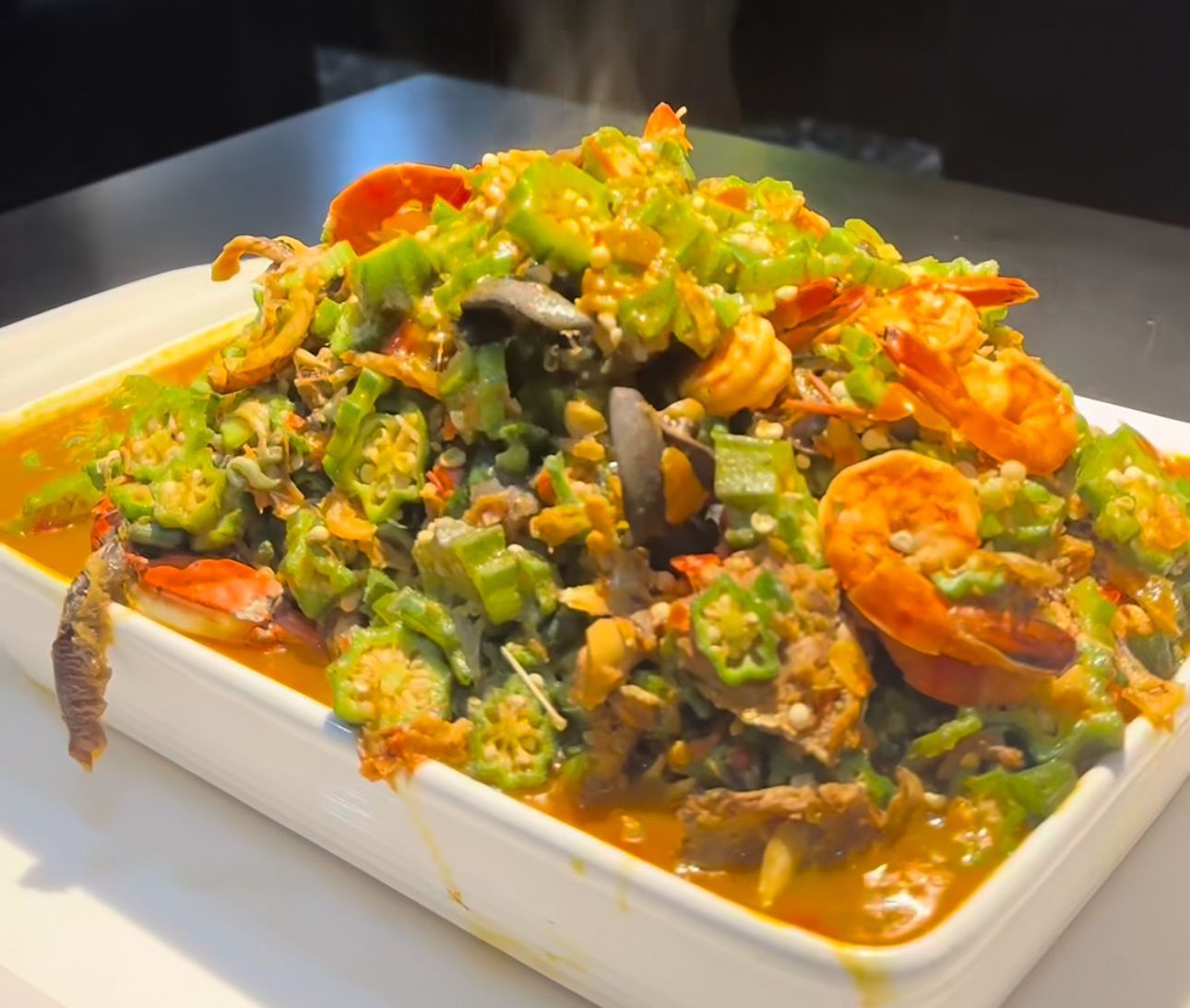 Okra seafood stew in a white serving dish