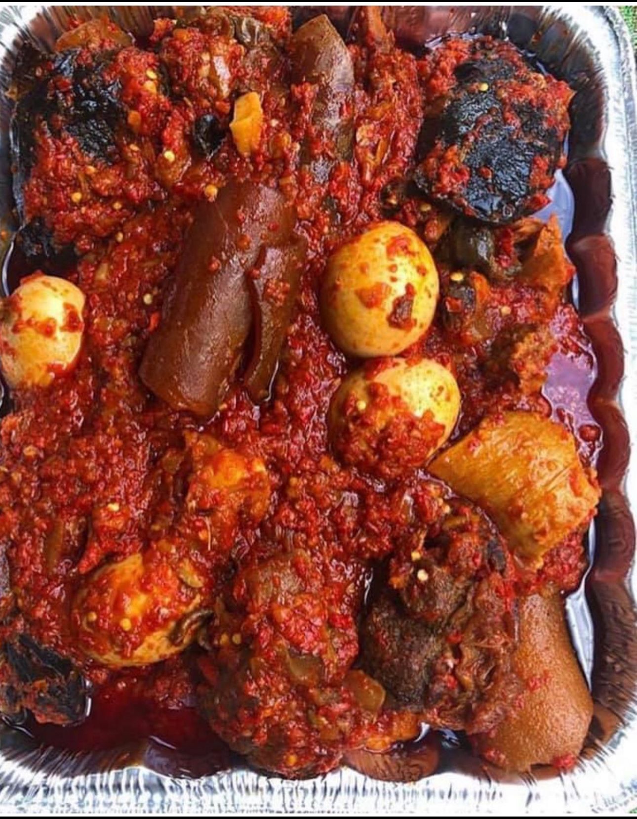 A catering tray of peppered meat and eggs